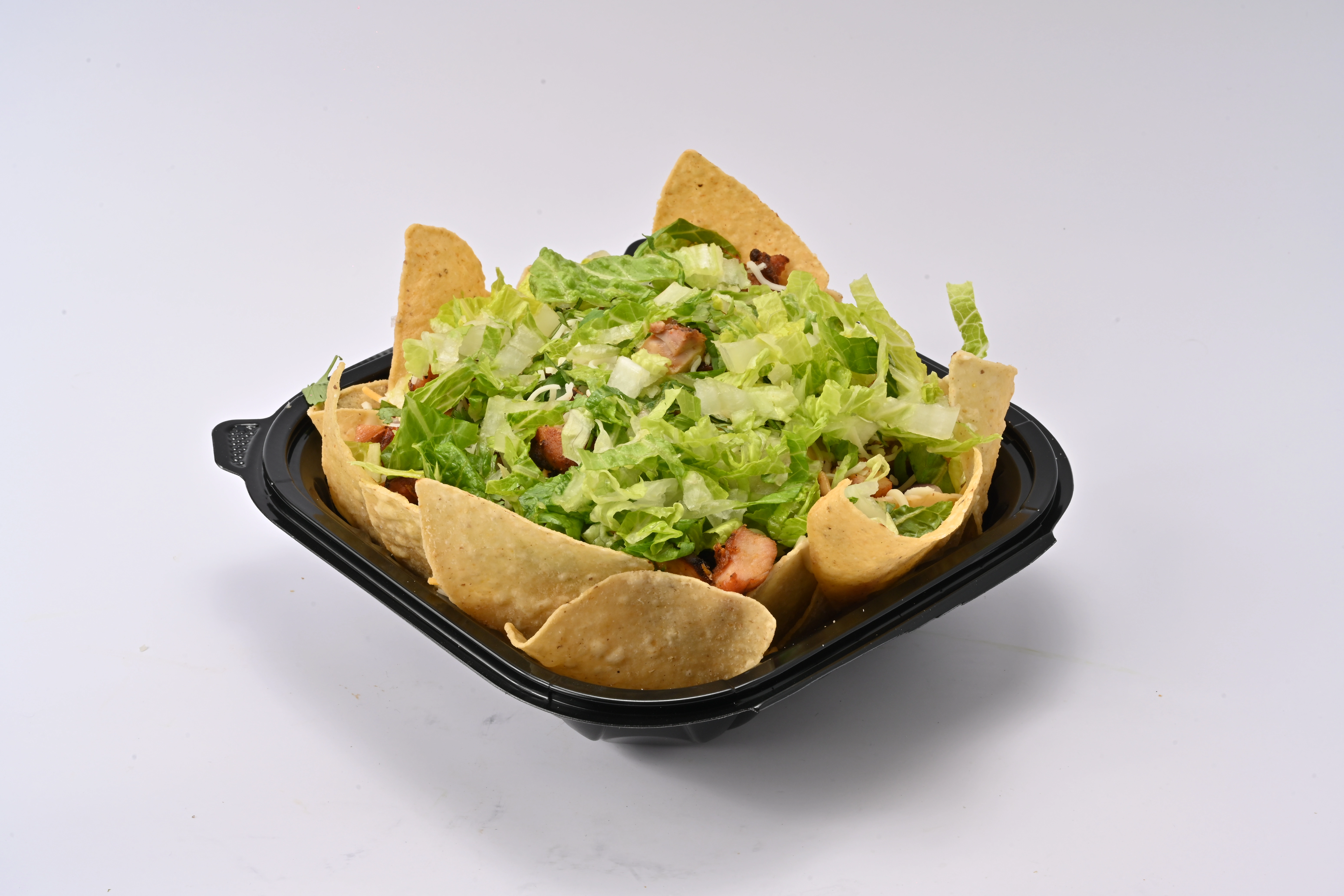 Taco Tek loaded nachos piled with melted cheese and toppings